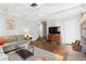Bright living room featuring hardwood floors, a ceiling fan and access to other rooms at 1222 E Powhatan Ave, Tampa, FL 33604