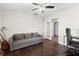 Bright living room featuring hardwood floors, a ceiling fan, and a grey couch perfect for relaxing or entertaining at 1222 E Powhatan Ave, Tampa, FL 33604