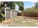 Backyard shot showing the shed and stone walkway with landscaping at 1222 E Powhatan Ave, Tampa, FL 33604