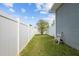 Fenced backyard with a small tree and grass at 14493 Promenade Pkwy, Odessa, FL 33556