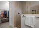 Bathroom features a tiled shower and a walk-in closet with storage and hanging racks at 14493 Promenade Pkwy, Odessa, FL 33556
