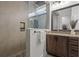 Bathroom boasts granite countertops, dark cabinets, tiled shower and a glass divider at 14493 Promenade Pkwy, Odessa, FL 33556