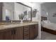 Bathroom boasts double sinks, granite countertops, dark cabinets and a view to the bedroom at 14493 Promenade Pkwy, Odessa, FL 33556