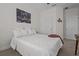 Bedroom features a comfortable bed, neutral carpet, and bright lighting at 14493 Promenade Pkwy, Odessa, FL 33556