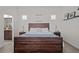 Bedroom features a wooden bed frame, two windows and decorations on the wall at 14493 Promenade Pkwy, Odessa, FL 33556