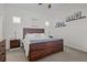 Bedroom features a wooden bed frame, two side tables and decorations on the wall at 14493 Promenade Pkwy, Odessa, FL 33556