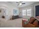 Bonus room has natural light, ceiling fan and blue accent wall with a mandala at 14493 Promenade Pkwy, Odessa, FL 33556