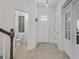Bright and airy foyer with tile flooring, a stylish front door, and easy access to a half bath at 14493 Promenade Pkwy, Odessa, FL 33556