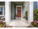 Inviting front door framed by columns and a decorative wreath, enhanced by colorful flower pots at 14493 Promenade Pkwy, Odessa, FL 33556