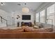 Open-concept living room with large windows, a comfortable leather sofa, and contemporary decor at 14493 Promenade Pkwy, Odessa, FL 33556