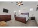Comfortable main bedroom featuring a large bed, ceiling fan, and access to an en-suite bathroom at 14493 Promenade Pkwy, Odessa, FL 33556