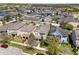 An aerial view of a neighborhood showcasing well-maintained homes, green spaces, and tree-lined streets at 14493 Promenade Pkwy, Odessa, FL 33556