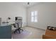 Bright home office featuring a desk, chair, neutral carpet, and plantation shutters at 14493 Promenade Pkwy, Odessa, FL 33556