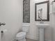 Bright powder room featuring a pedestal sink, decorative mirror, and modern wall art at 14493 Promenade Pkwy, Odessa, FL 33556
