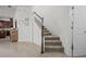 Carpeted staircase features natural wood handrail, white risers and access to an upstairs landing at 14493 Promenade Pkwy, Odessa, FL 33556