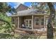 Outdoor porch with comfortable seating, brick accents, and French doors, perfect for relaxing outdoors at 15053 Peace Blvd, Spring Hill, FL 34610