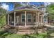 Covered back porch with seating, brick accents, and elegant architecture, perfect for outdoor relaxation at 15053 Peace Blvd, Spring Hill, FL 34610