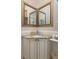 Bathroom with ornate vanity, granite counters and decorative mirrors at 15053 Peace Blvd, Spring Hill, FL 34610