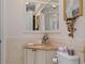 Charming bathroom featuring decorative mirror and granite countertop at 15053 Peace Blvd, Spring Hill, FL 34610