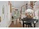 Grand foyer with a staircase, a piano, hardwood floors, and double doors leading to the outside at 15053 Peace Blvd, Spring Hill, FL 34610
