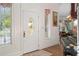 Elegant home entryway featuring a decorative glass door, intricate trim, and hardwood floors at 15053 Peace Blvd, Spring Hill, FL 34610