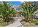 Charming home with mature palm trees, brick accents, and a welcoming walkway leading to the front entrance at 15053 Peace Blvd, Spring Hill, FL 34610