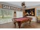 Entertainment room with a pool table, unique decor, and sliding glass doors at 15053 Peace Blvd, Spring Hill, FL 34610