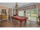 Spacious game room with a pool table, decorative lighting and unique portrait art along the wall at 15053 Peace Blvd, Spring Hill, FL 34610