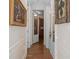Hallway leading to a room with dark wood cabinets and tile flooring at 15053 Peace Blvd, Spring Hill, FL 34610