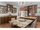 Gourmet kitchen featuring a large island, custom cabinets, and chandelier lighting at 15053 Peace Blvd, Spring Hill, FL 34610