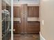 Beautiful laundry room with dark wood cabinets and tile flooring at 15053 Peace Blvd, Spring Hill, FL 34610