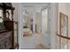 Charming living room view through french doors with traditional furnishings and striped wallpaper at 15053 Peace Blvd, Spring Hill, FL 34610