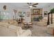 Inviting living room with brick fireplace, TV, and comfortable seating arrangement at 15053 Peace Blvd, Spring Hill, FL 34610