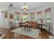 Bright living room with bay window, chandelier, hardwood floors, and elegant furnishings at 15053 Peace Blvd, Spring Hill, FL 34610