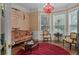 Bright living room with large windows, decorative chandelier, and comfortable seating at 15053 Peace Blvd, Spring Hill, FL 34610
