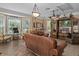 Well-appointed living room with large windows, leather couches, and entertainment center at 15053 Peace Blvd, Spring Hill, FL 34610