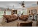 Spacious living room featuring large windows, leather couches, and unique decor at 15053 Peace Blvd, Spring Hill, FL 34610