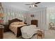 Spacious main bedroom featuring a cozy seating area, elegant decor, and a calming color palette at 15053 Peace Blvd, Spring Hill, FL 34610