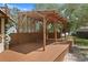 Expansive outdoor space with a covered pergola, offering shade and a versatile area for gatherings and relaxation at 15053 Peace Blvd, Spring Hill, FL 34610