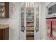 Walk-in pantry with glass doors and ample shelving for organized storage at 15053 Peace Blvd, Spring Hill, FL 34610