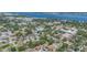Panoramic aerial view of a residential area with mature trees, a river in the background and a clear blue sky at 1540 7Th E Ave, Bradenton, FL 34208