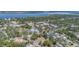 Breathtaking aerial view showcasing a residential neighborhood with a river and cityscape in the distance beneath a clear sky at 1540 7Th E Ave, Bradenton, FL 34208