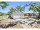 Spacious backyard with partial fencing and mature trees providing shade and privacy at 1540 7Th E Ave, Bradenton, FL 34208