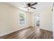 Well-lit bedroom with a window, modern ceiling fan, and an open doorway leading to the bathroom at 1540 7Th E Ave, Bradenton, FL 34208