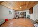 Spacious basement area with wood floors and ceilings provides versatile space for storage, recreation, and hobbies at 19 N Pine Cir, Belleair, FL 33756