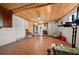 Spacious basement area with wood ceiling and floors is ideal for a recreation room or additional storage at 19 N Pine Cir, Belleair, FL 33756