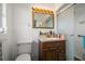 Bathroom with granite countertop vanity, a framed mirror, and a glass shower at 19 N Pine Cir, Belleair, FL 33756