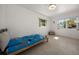 Bright bedroom with terrazzo floors and natural light from the two windows at 19 N Pine Cir, Belleair, FL 33756