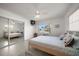 Bright bedroom with neutral tones, a ceiling fan, and views of the water at 19 N Pine Cir, Belleair, FL 33756