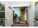 View from the doorway to the landscaped pathway outside at 19 N Pine Cir, Belleair, FL 33756
